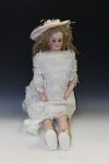 A bisque head and shoulder doll