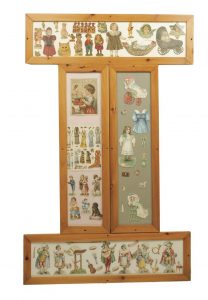 Four wood frames of various paper dolls