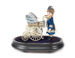 Miniature all-bisque doll with pram under glass dome